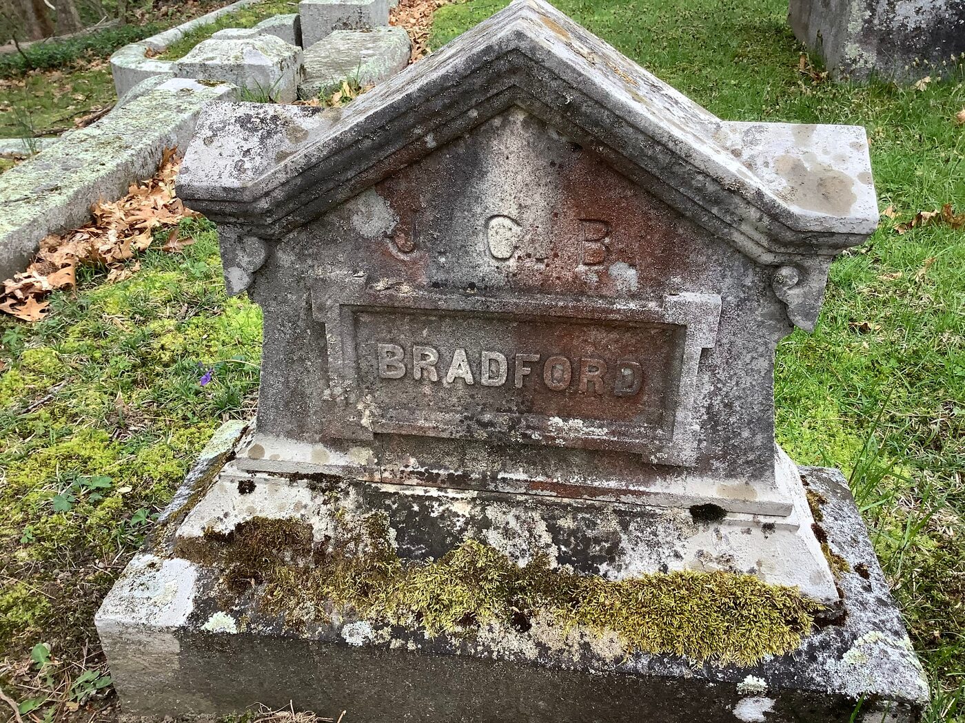 Jonathan Bradford's own small marker at Pine Grove Cemetery, Milford, with the initials J. C. B. in the pediment, beside the family monument