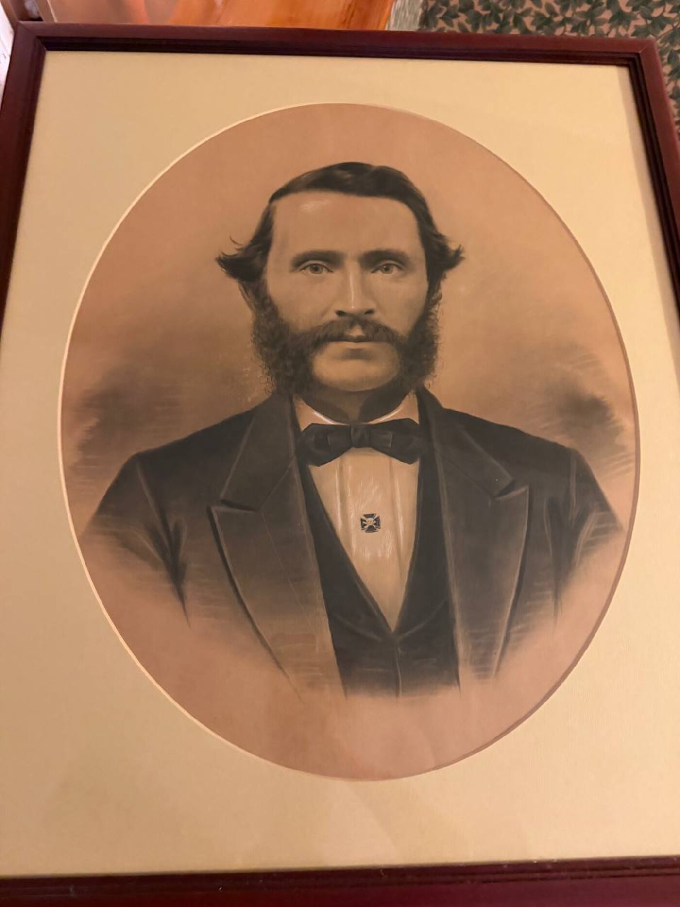 The charcoal portrait as it hangs today, in a later oval mat and frame
